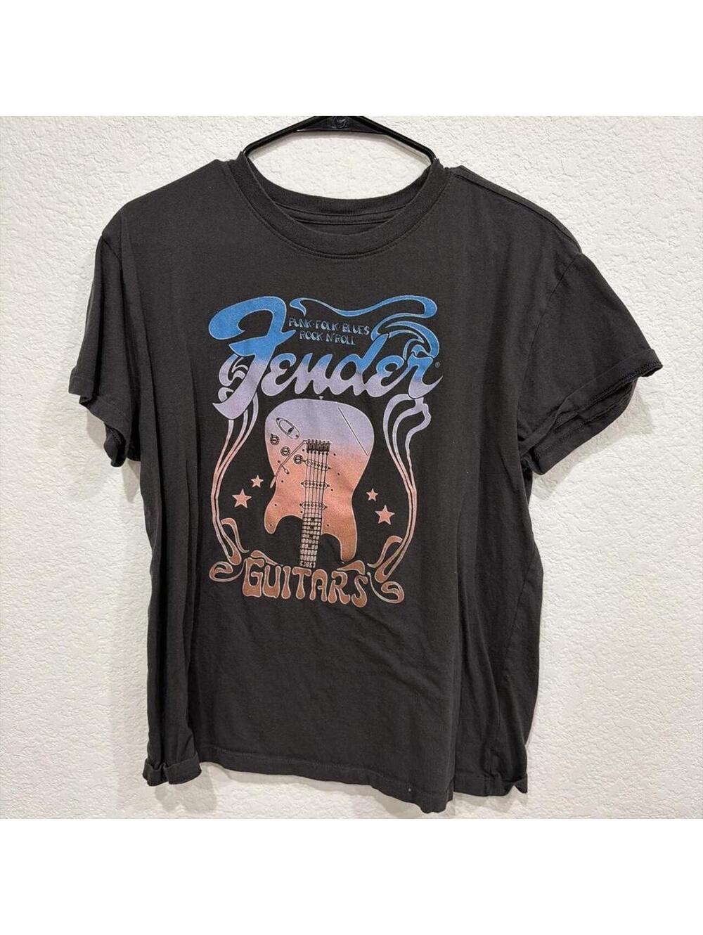 Black Fender Guitars graphic tee featuring a colorful retro guitar design.